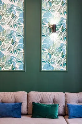 a couch in a room with two pictures on the wall at VINTAGE SZPITALNA APARTMENT in Kraków