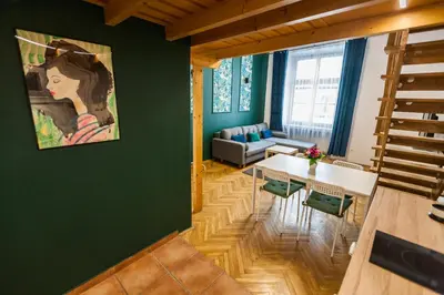 a living room with a table and a couch at VINTAGE SZPITALNA APARTMENT in Kraków