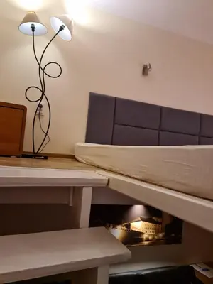 a room with a couch and a table and a lamp at AMBER APATRTAMENt 7 in Kraków