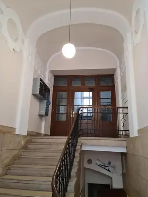 a staircase in a building with a large door at AMBER APATRTAMENt 7 in Kraków
