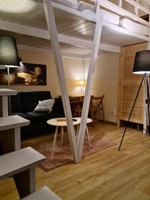 a living room with a loft bed and a table at AMBER APATRTAMENt 7 in Kraków