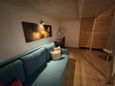 a living room with a blue couch and a table at AMBER APATRTAMENt 7 in Kraków