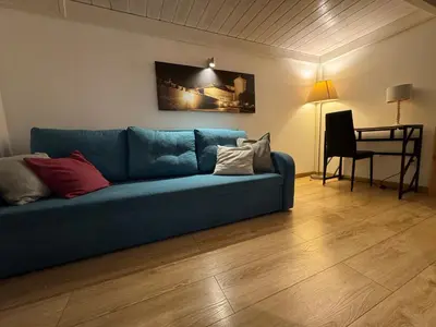 a blue couch in a living room with a table at AMBER APATRTAMENt 7 in Kraków