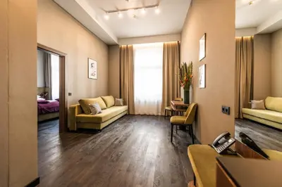 a living room with a couch and a table at Liebeskind Boutique Hotel Old Town in Kraków