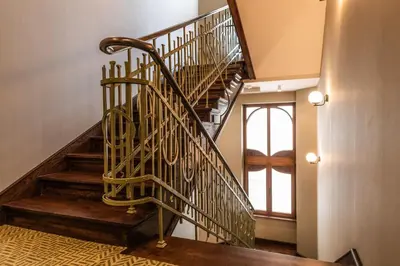 a spiral staircase in a home with wooden floors at Liebeskind Boutique Hotel Old Town in Kraków