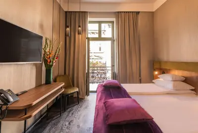 a hotel room with a bed and a desk at Liebeskind Boutique Hotel Old Town in Kraków
