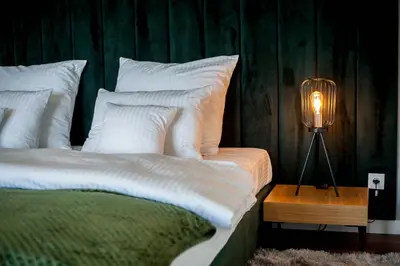 a bedroom with two beds and a lamp on a table at Willa pod Lanckoroną in Izdebnik