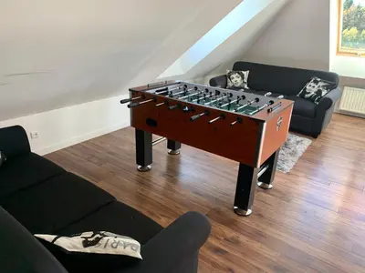 a living room with a foosball table in a living room at Willa pod Lanckoroną in Izdebnik