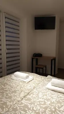 a bedroom with a bed with two towels on it at Dom Pod Groniem in Rzyki