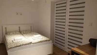 a bedroom with a bed with towels on it at Dom Pod Groniem in Rzyki