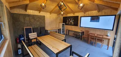 an overhead view of a restaurant with tables and a screen at Dom Pod Groniem in Rzyki