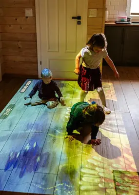 a group of children playing on a floor at Domki Dobre Miejsce in Rabka