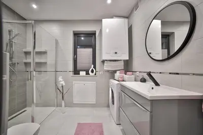 a bathroom with a shower and a sink and a mirror at Domki Pod Lasem MM in Rabka