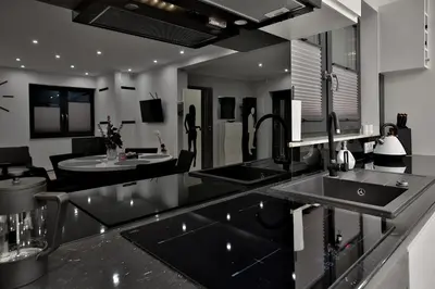 a kitchen with two sinks and a living room at Domki Pod Lasem MM in Rabka