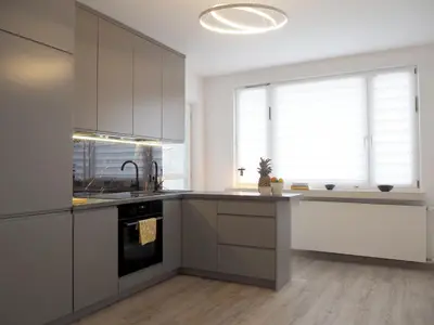 a kitchen with white cabinets and a sink at Telimeny in Kraków