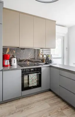 a kitchen with white cabinets and an oven at Telimeny in Kraków