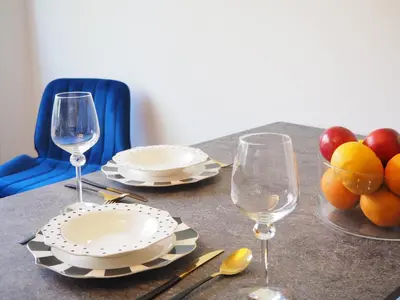 a table with plates and glasses and fruit on it at Telimeny in Kraków