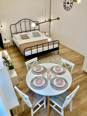 a room with a table and chairs and a bed at Duo 1 Debniki Cozy Kraków Base 10-min to Wawel & Kazimierz Fast Wi-Fi in Kraków
