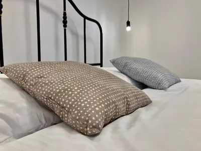 two pillows sitting on top of a bed at Duo 1 Debniki Cozy Kraków Base 10-min to Wawel & Kazimierz Fast Wi-Fi in Kraków