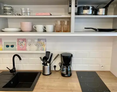 a kitchen counter with a sink and utensils at Duo 1 Debniki Cozy Kraków Base 10-min to Wawel & Kazimierz Fast Wi-Fi in Kraków