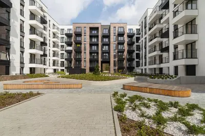 a courtyard in an apartment complex with tall buildings at Cosy Apartment at the Main Station by Noclegi Renters in Kraków