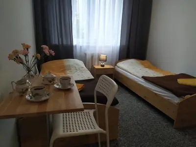 a bedroom with a table and a bed and a table and chairs at Centro Unita in Kraków