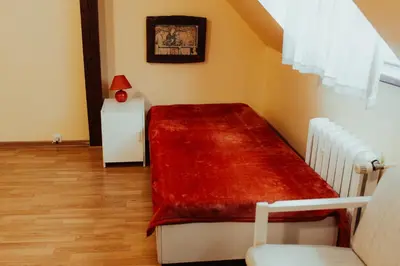a bedroom with a bed with a red blanket at Centro Unita in Kraków