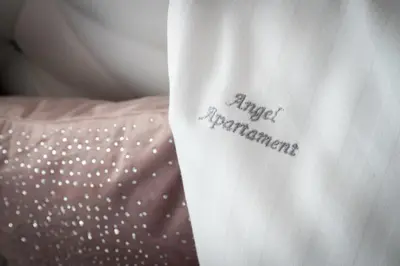 a sign on the side of a pillow with the words anger aggravators on it at Angel Apartments 2 in Kraków