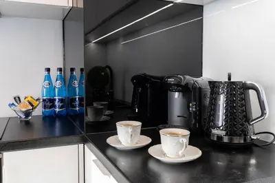 two cups of coffee on a counter in a kitchen at Angel Apartments 2 in Kraków