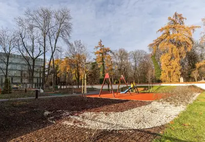 a park with a playground with a swing at Angel Apartments 2 in Kraków