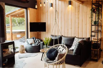 a living room with a couch and a swing at CzillChata - dom z balią in Maków Podhalański