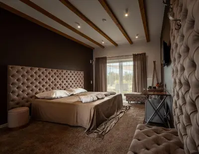 a bedroom with a large bed and a large window at Boski Zakątek in Wielka Wieś