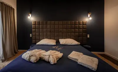 a bedroom with a bed with towels on it at Boski Zakątek in Wielka Wieś