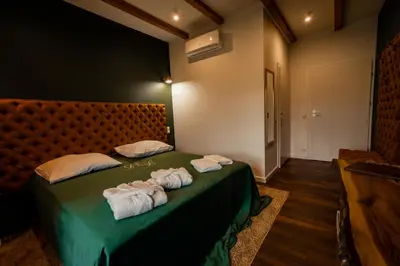 a bedroom with a green bed with towels on it at Boski Zakątek in Wielka Wieś