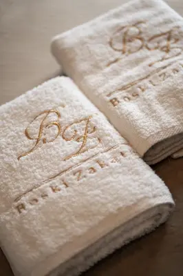 two white towels with the word baby written on them at Boski Zakątek in Wielka Wieś