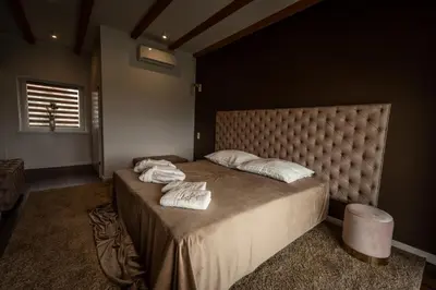 a bedroom with a large bed with two towels on it at Boski Zakątek in Wielka Wieś