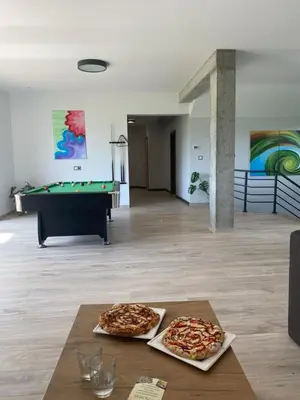 two pizzas sitting on a table in a room with a pool table at HamakoweLove in Dąbrówka