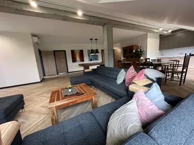 a living room with blue couches and a table at HamakoweLove in Dąbrówka