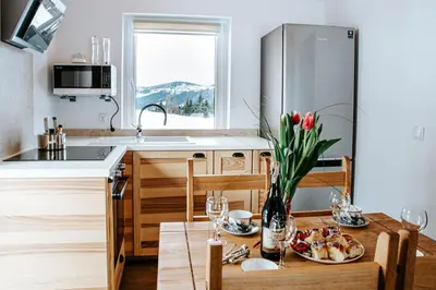 a kitchen with a table with a plate of food on it at Ostoja Jaworskie in Stryszawa