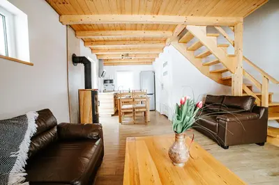 a living room with a couch and a table at Ostoja Jaworskie in Stryszawa