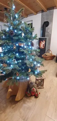 a blue christmas tree with a teddy bear under it at Ostoja Jaworskie in Stryszawa