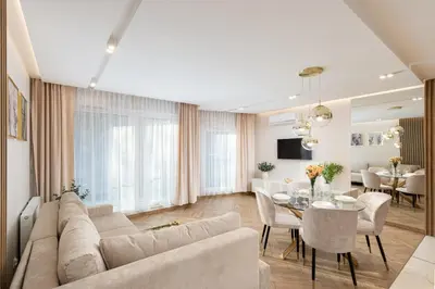 a living room with a couch and a dining room at Glossy Apart G9 in Kraków