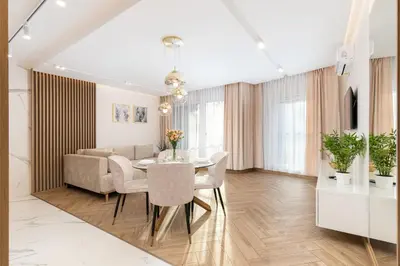 a kitchen and dining room with a table and chairs at Glossy Apart G9 in Kraków