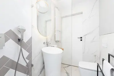 a white bathroom with a shower and a sink at Mogilska Apartments by Renters Prestige in Kraków