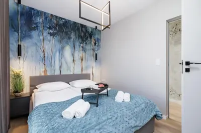 a bedroom with a bed with towels on it at Mogilska Apartments by Renters Prestige in Kraków