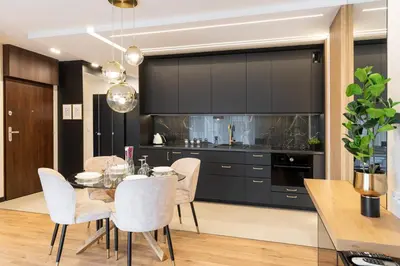 a dining room with a table and white chairs at Glossy Apart G20 in Kraków
