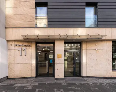 an entrance to an office building with revolving doors at Glossy Apart G20 in Kraków