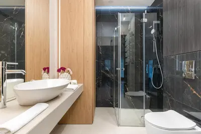 a bathroom with a sink and a shower at Glossy Apart G20 in Kraków