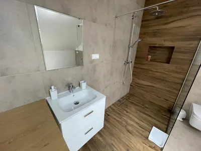 a bathroom with a sink and a shower at Apartament Rynek 13 z parkingiem - Centrum Bochni in Bochnia