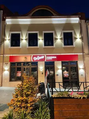 a fast food restaurant with a sign in front of it at Apartament Rynek 13 z parkingiem - Centrum Bochni in Bochnia